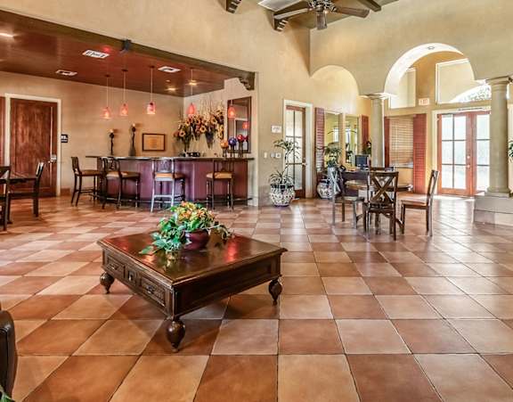 a large kitchen with a long island with chairs and a dining table
