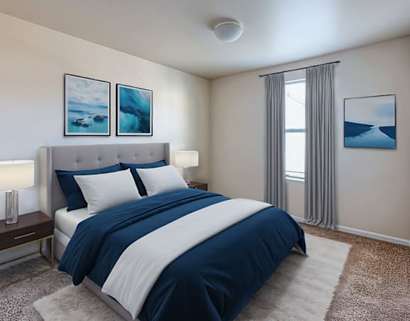 a bedroom with a bed with pillows and two lamps