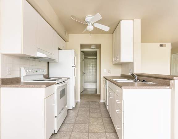a large kitchen with a long island with chairs and a dining table