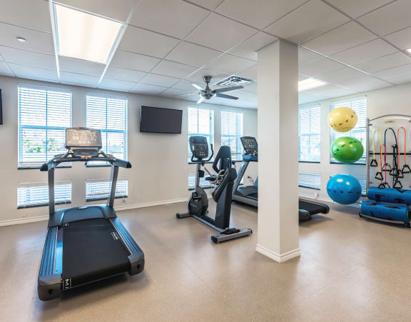 The fitness center with exercise equipment at Villas on the Strand apartments in Galveston, TX