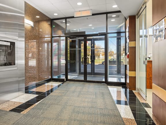 A hallway with a black and white checkered floor.