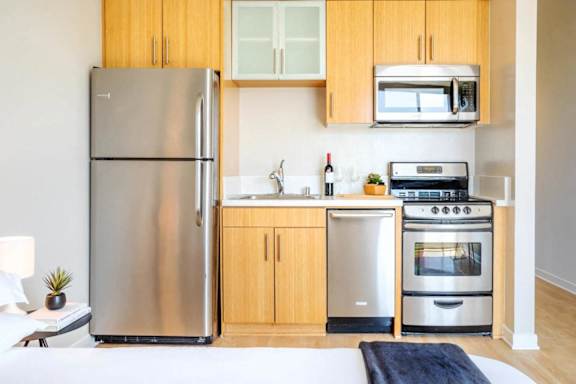 a kitchen with stainless steel appliances and wooden cabinets