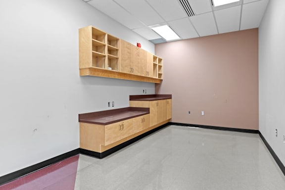 A room with a bench and storage drawers.