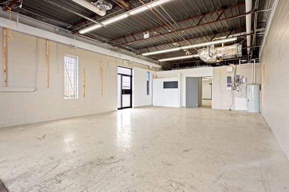 A large, empty industrial space with a concrete floor and walls.
