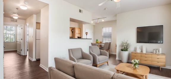 a Clubhouse lobby with a fireplace and a table with chairs with a stone kitchen island