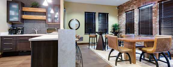 a large clubhouse kitchen and dining area with a fireplace and a table and chairs