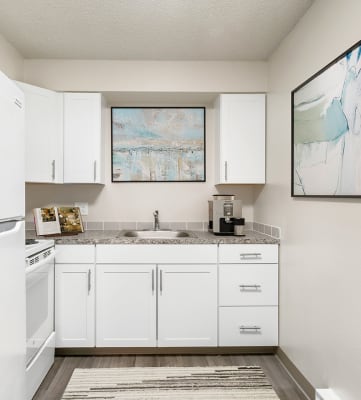 a kitchen with white cabinets and white appliances at Wildflower, Kennewick