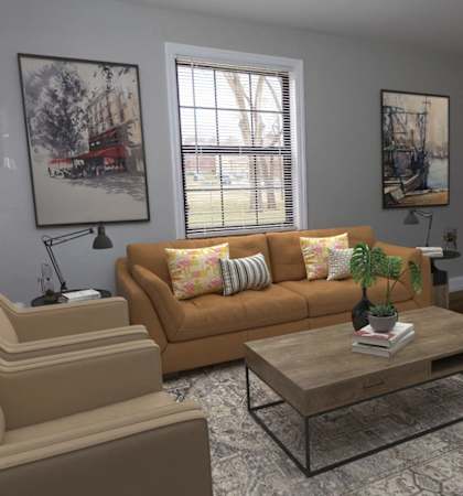 A living room with a brown couch, a coffee table, and a painting on the wall.