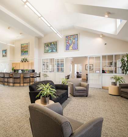 a large living room with couches and chairs and a table and chairs