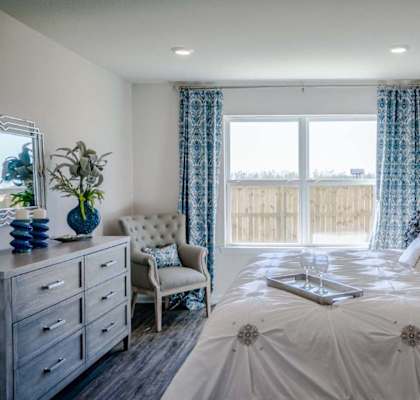 a bedroom with a large window and a bed