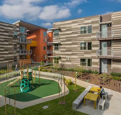 a playground is in the middle of a group of apartment buildings
