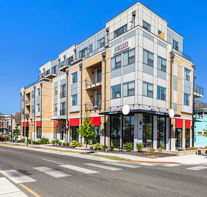 an apartment building on the corner of a city street