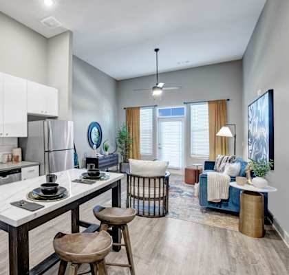 an open kitchen and living room with a table and chairs