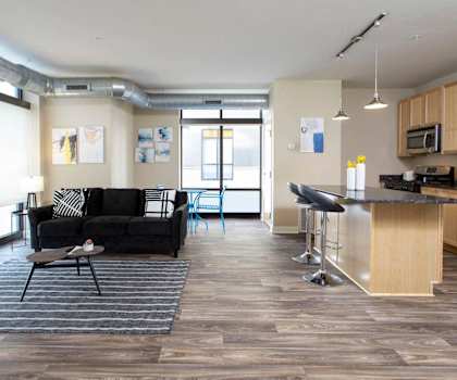 a living room with a kitchen and a couch
