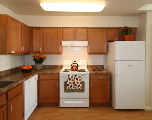 a living room with a kitchen and a balcony