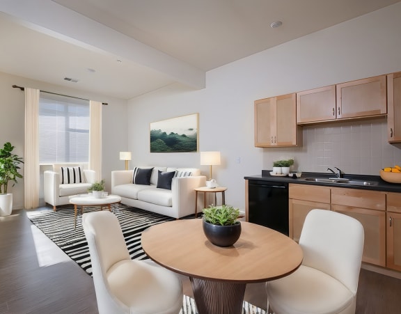 a living room with a couch and a dining table and a refrigerator surrounded by cabinets