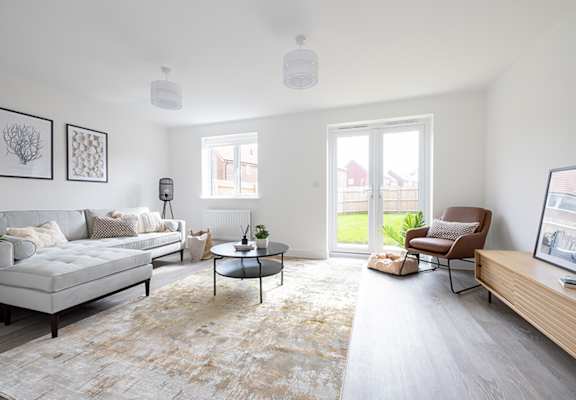 A living room with a grey sofa, a coffee table, and a chair.