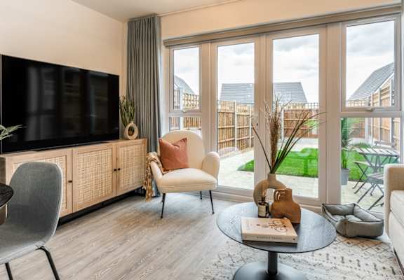 a living room with a tv and a balcony