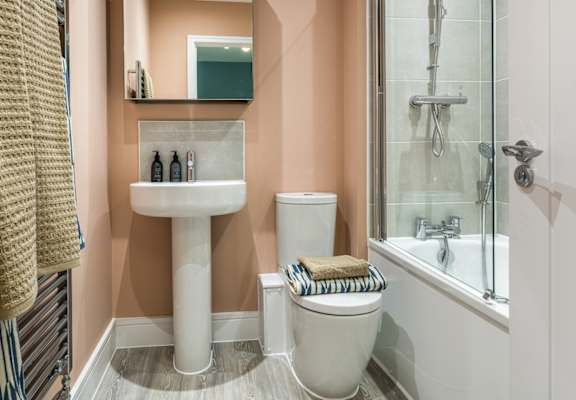 a bathroom with a toilet and a sink and a shower