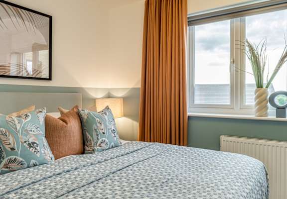 a blue and white bedroom with a bed and a window