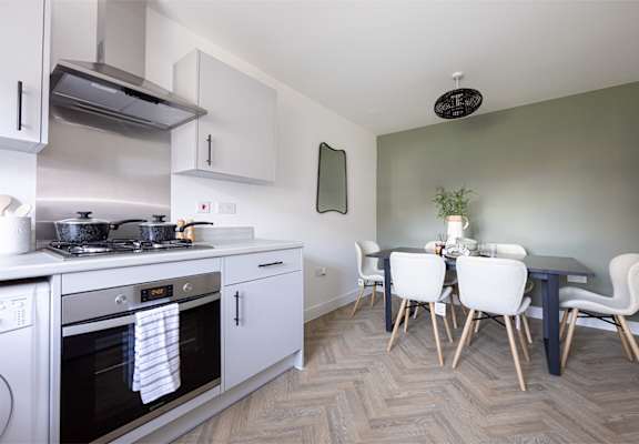 a kitchen and dining room with a table and chairs