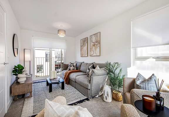 A living room with a grey couch and a coffee table.