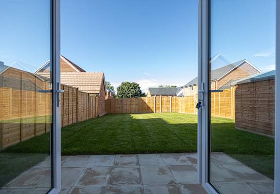 A view of a backyard through a glass door.