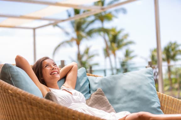 Woman Relaxing by Palm Trees at Heritage Cove, Stuart, Florida 34997