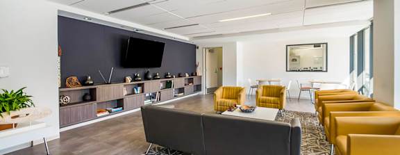 a large clubhouse kitchen and dining area with a fireplace and a table and chairs