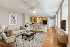 A living room with a couch, chair, and coffee table.