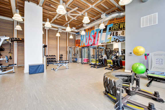 A gym with a variety of equipment including a leg press machine. at Coda at Bryant Street, Washington, DC 20002