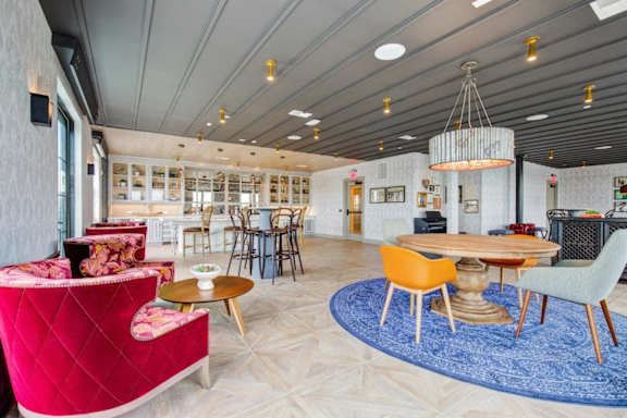 A modern living room with a red sofa and a wooden coffee table. at Coda at Bryant Street, Washington, DC 20002