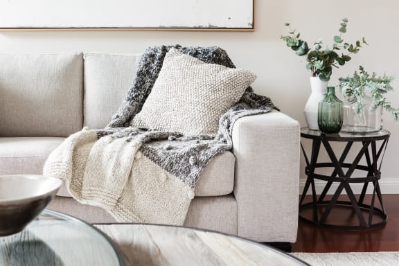 a living room with a couch and a blanket on it at Creston Point, Seattle, Washington