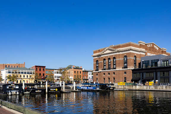 an aerial view of a building with a city in the background