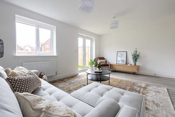 a living room with a couch and a glass table