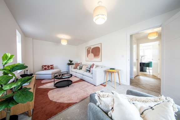 a living room with a couch and a glass table