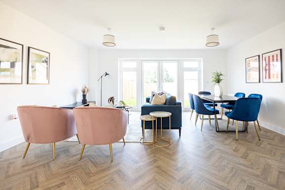 a living room with a couch and a glass table