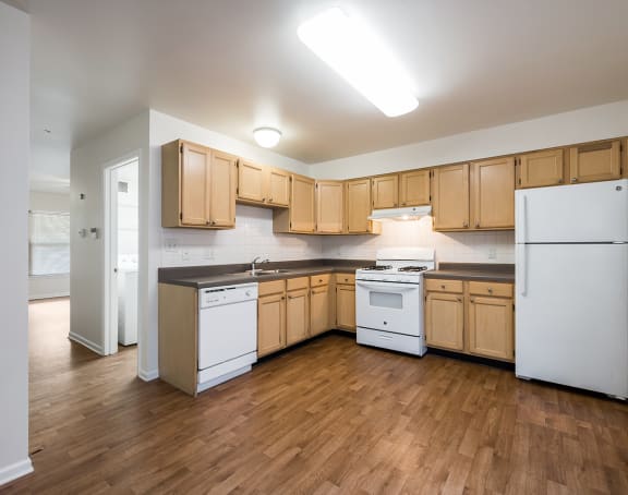 a living room with a kitchen and a balcony
