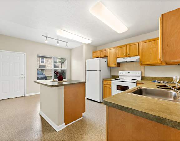 a living room with a kitchen and a balcony