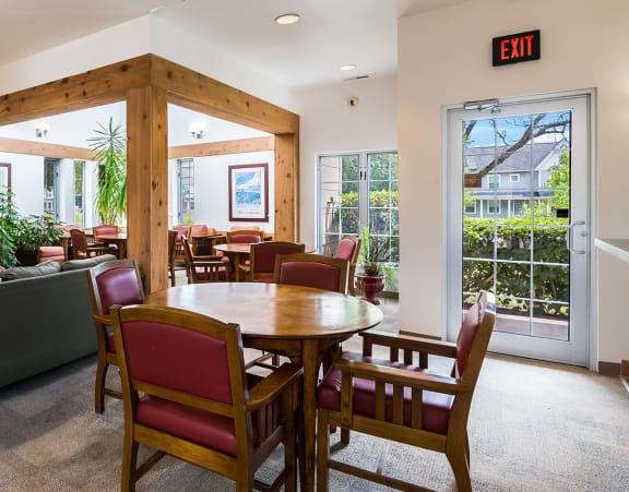 a large kitchen with a long island with chairs and a dining table