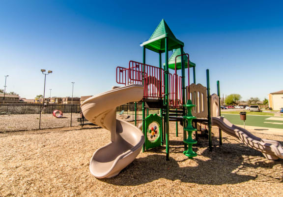 a playground with two slides and a climbing structure