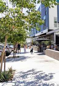 A group of people are sitting outside of a restaurant.at 1048 Manzanita, Los Angeles, 90029