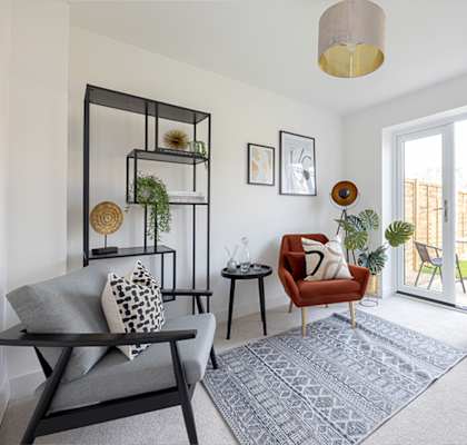 a living room with a couch and a chair and a balcony