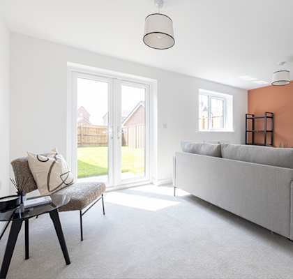 a living room with a couch and a chair and a sliding glass door