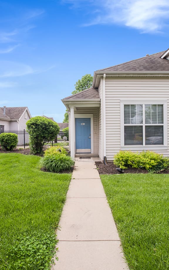 a row of houses with a sidewalk in front of them