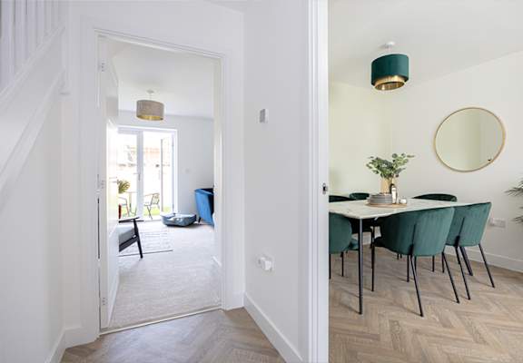 A dining room with a table set for four.
