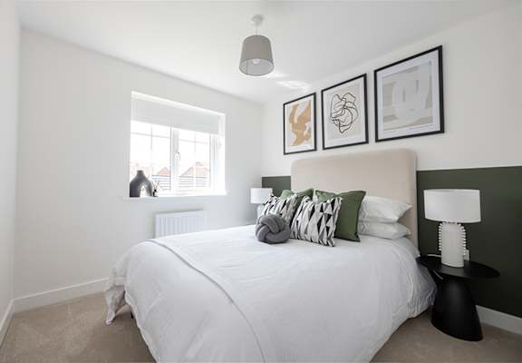 a bedroom with a large bed and a window