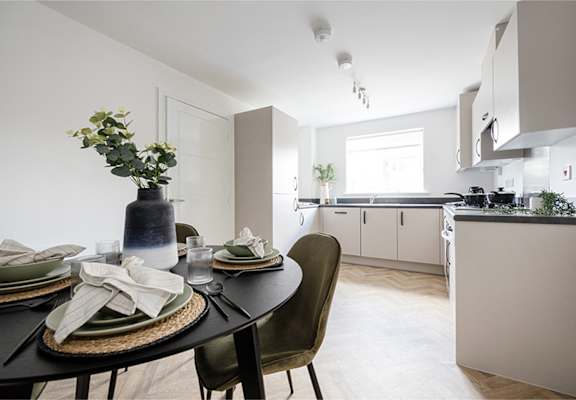 A modern dining room with a table set for a meal.