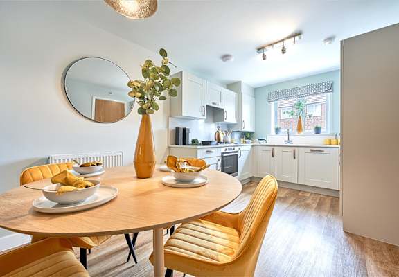 a kitchen and dining room with a wooden table and chairs