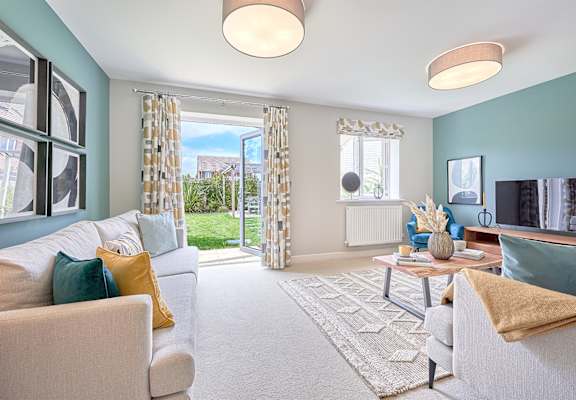 a living room with blue walls and a sliding glass door